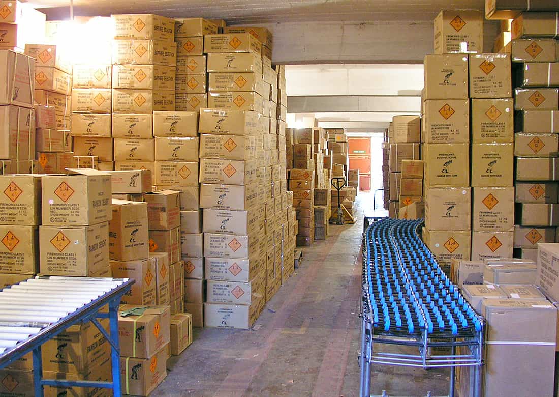 Fireworks being stored in a retailer's licensed store. This is a fully licensed explosives store in a fortified bunker with blast-proof doors and many hundreds of metres separation distance to any nearby structures. In fact many stores are on former military bases as tough UK laws on storage make them ideal for this purpose.